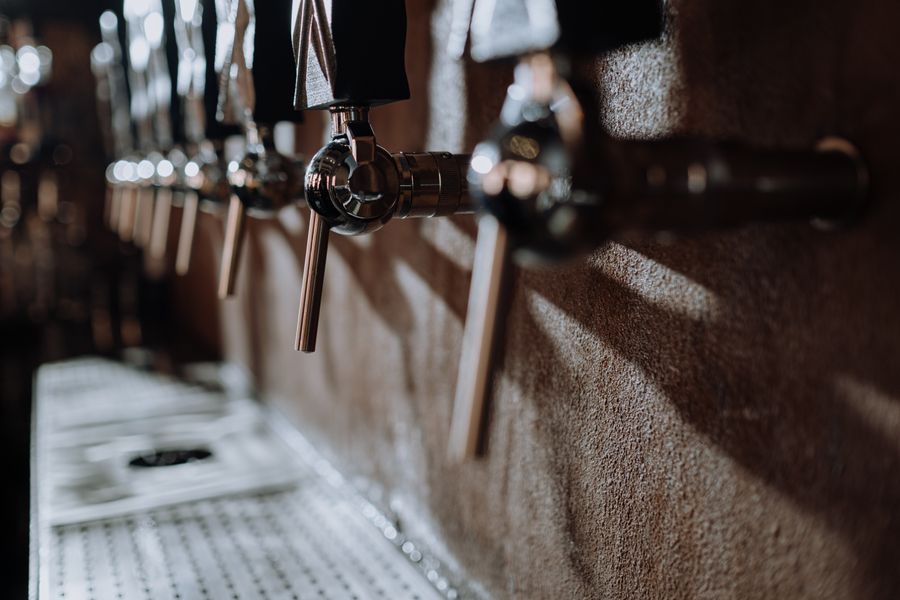 Beer taps in a moody bar
