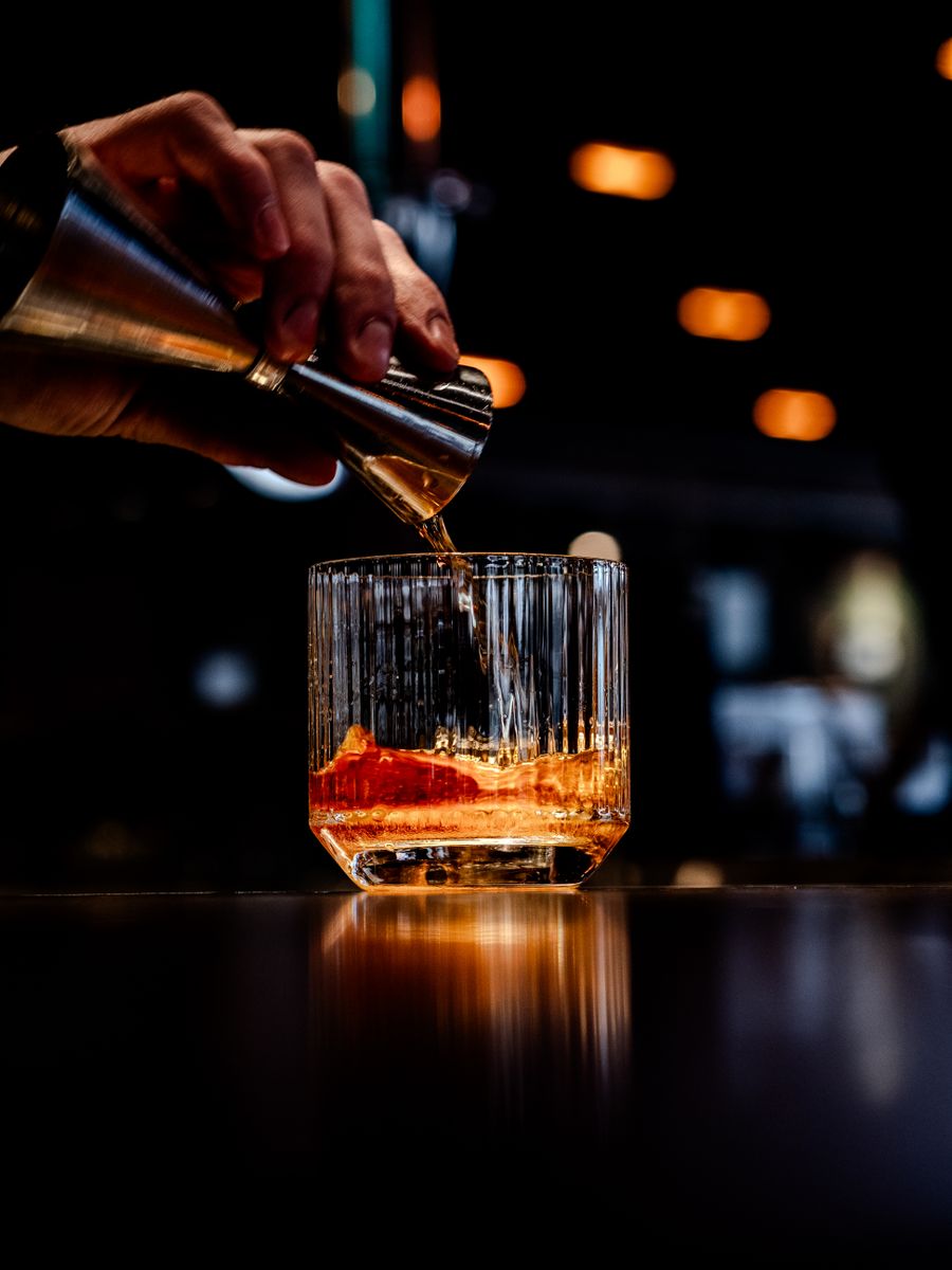 Whisky poured over ice at the bar